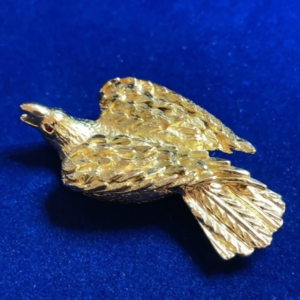 Vintage ‘60s gold tone Nesting eagle with red rhinestones